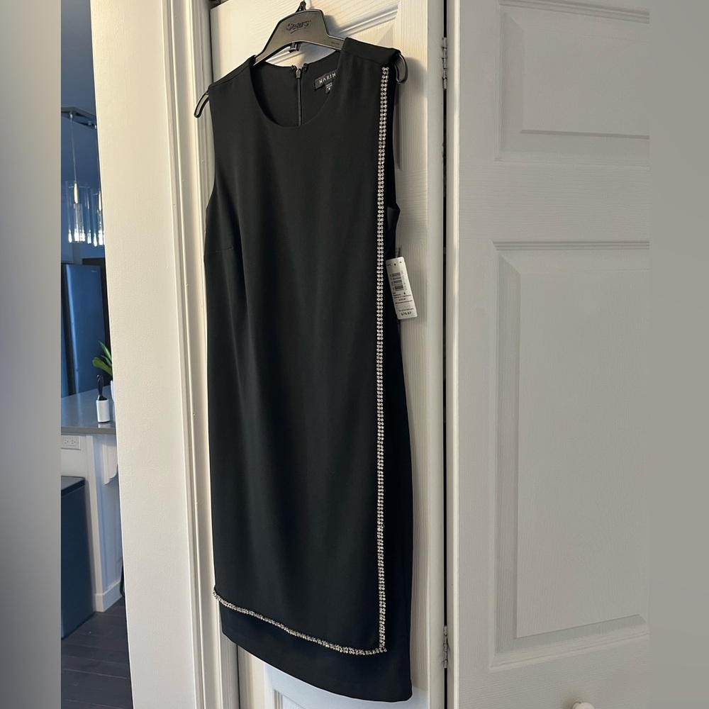 Black alone dress with bejeweled edging. New with tags from Sears.
